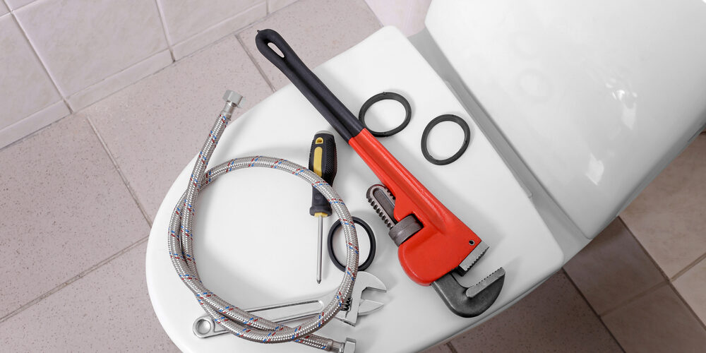 Plumber's,Tools,On,Toilet,At,Home